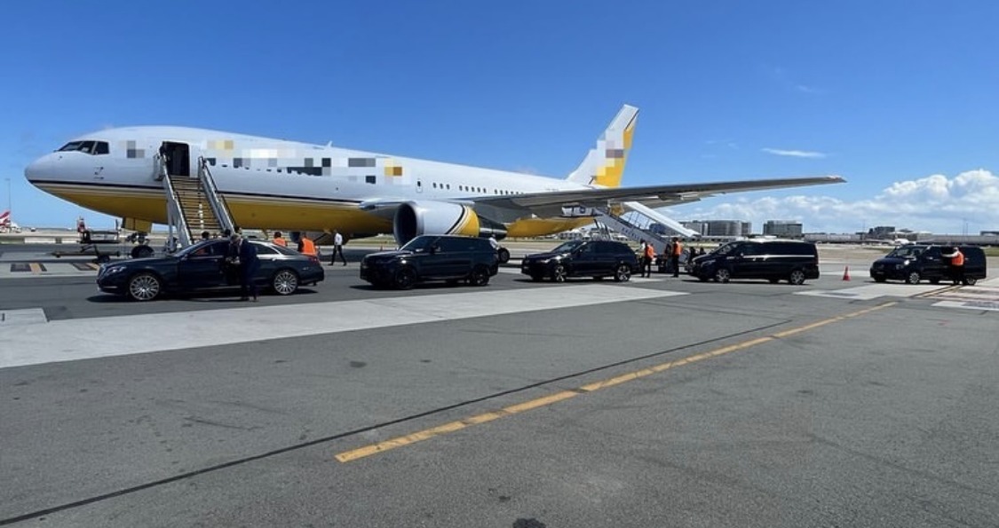 A protection fleet staged alongside an aircraft on an airport apron, doors open and waiting.
