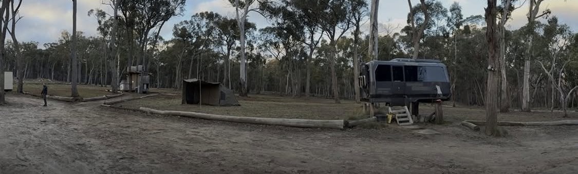 The hostile environment training facility in regional New South Wales: a cleared bush camp with a shelter and a vehicle.