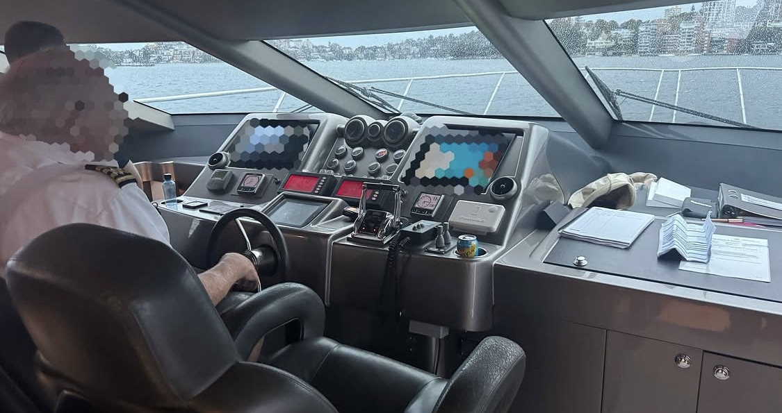 The bridge of a motor yacht underway, instrument screens and the helm position.